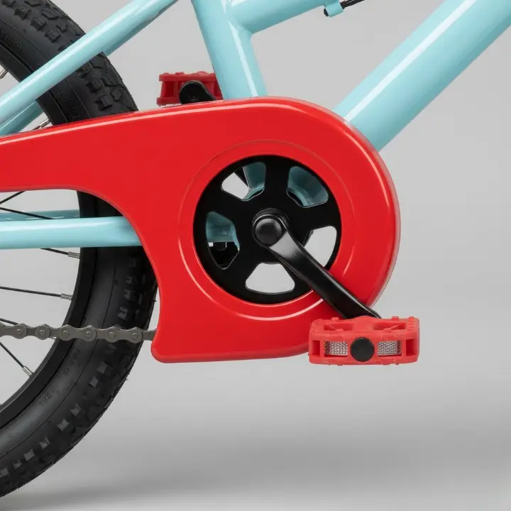 A detailed close-up of a kids' bicycle chain guard and easy-to-reach brake lever.