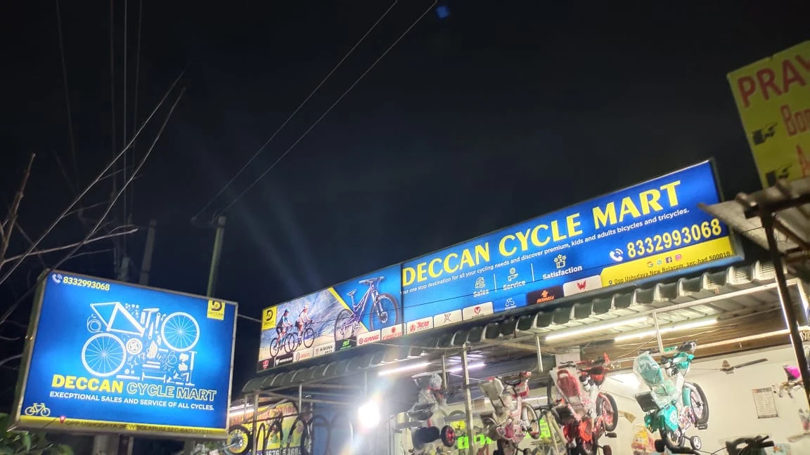 Deccan Cycle Mart storefront at night